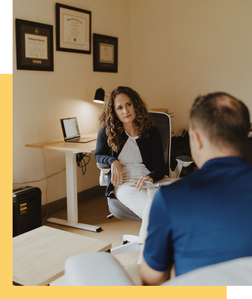 A therapist with her client in a warm yellow office